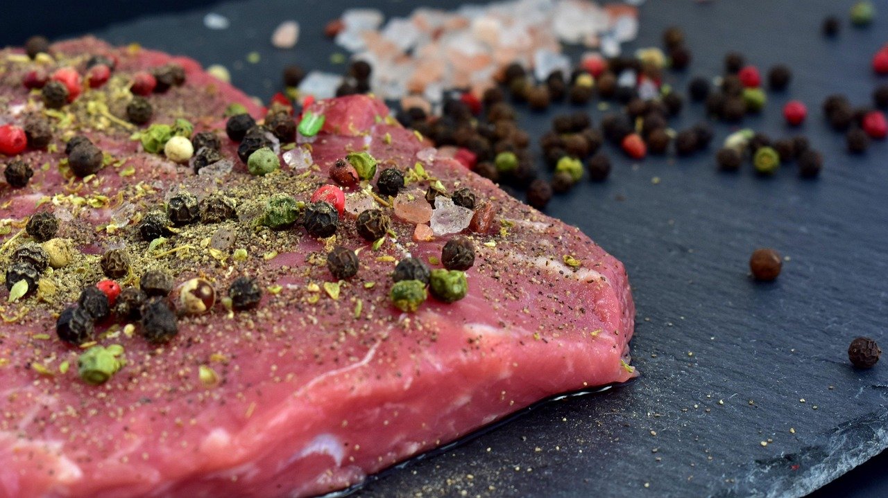 a piece of meat with spices on it